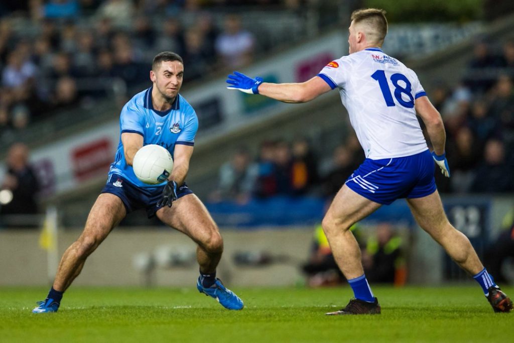 Dublin GAA player passing over Monaghan defender