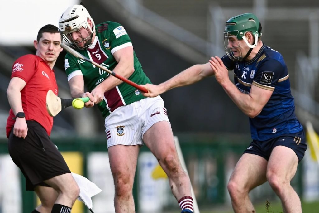 Galway hurling player winding up a shot