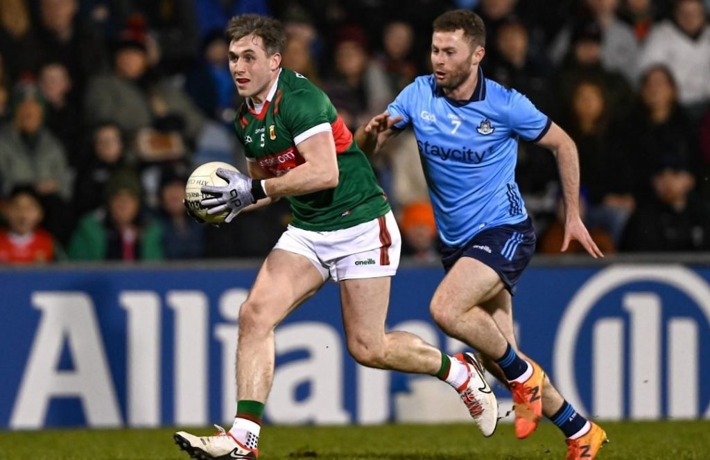Mayo Gaelic footballer running away from a Dublin player
