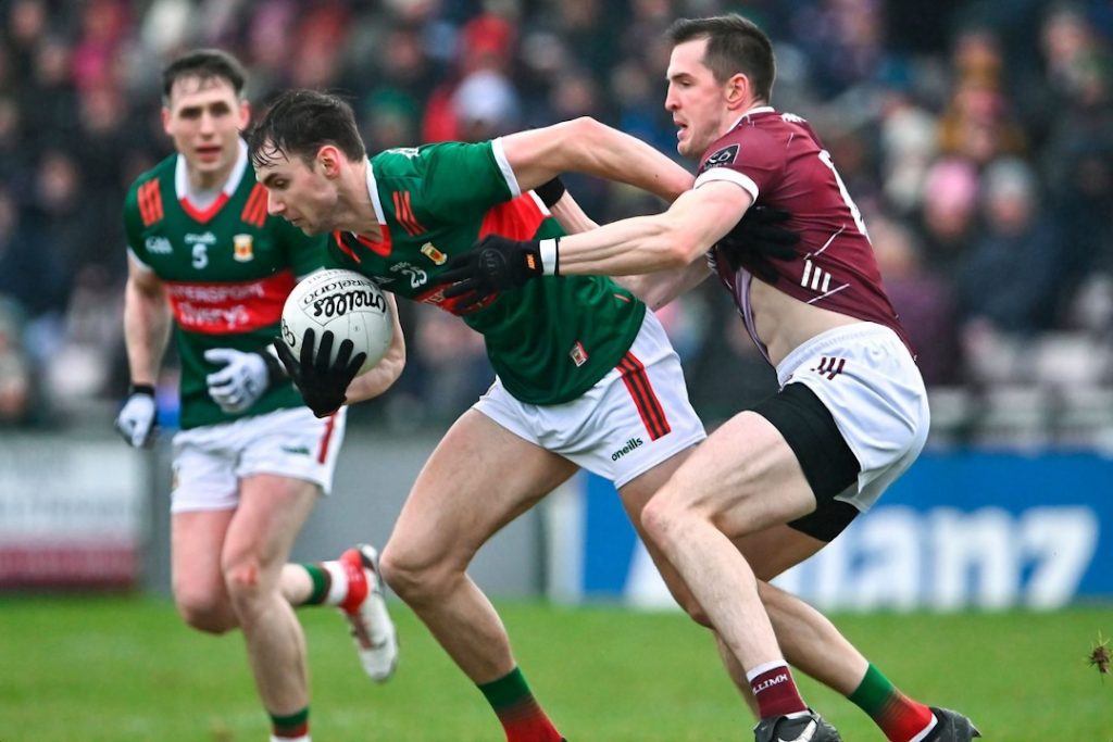 Mayo player trying to wrestle away from a tackle