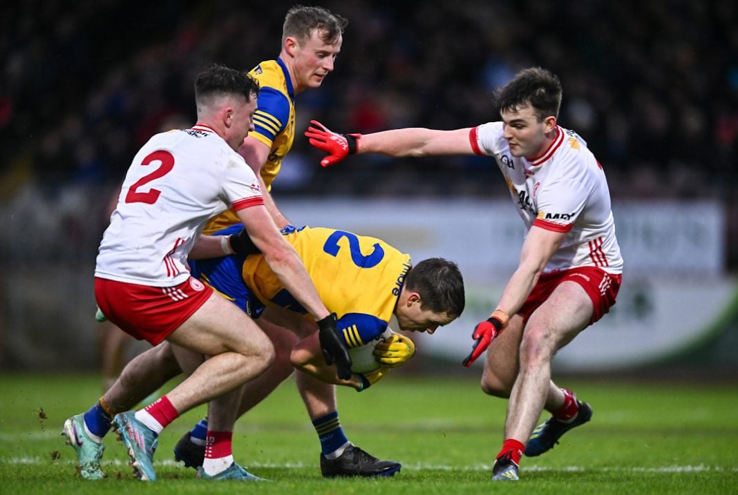 Tyrone GAA players trying to tackle a player
