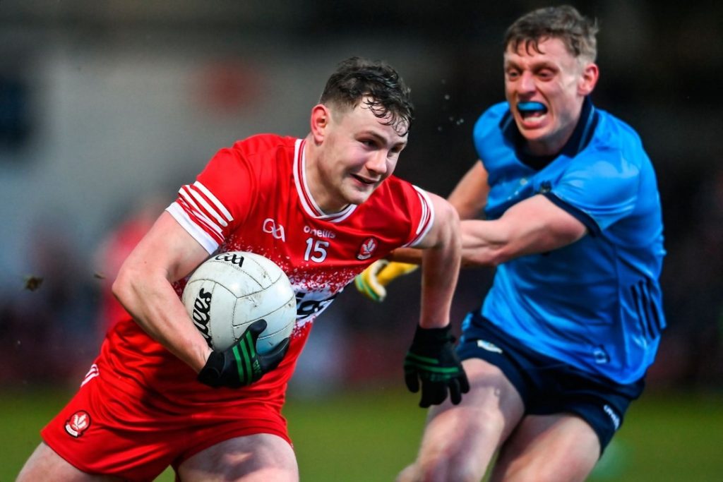 Derry GAA player running with the ball