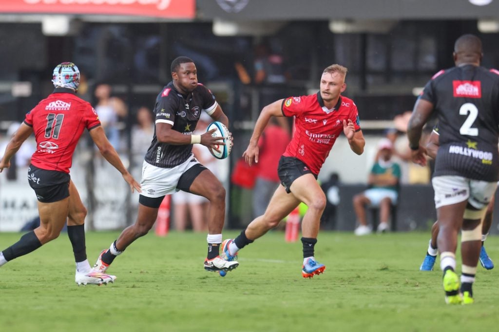 Emirates Lions players trying to tackle the Sharks
