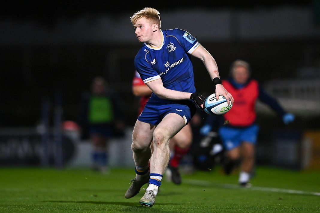 A Leinster Rugby player runs with the ball