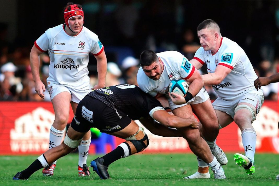 An Ulster Rugby player is tackled while running with the ball