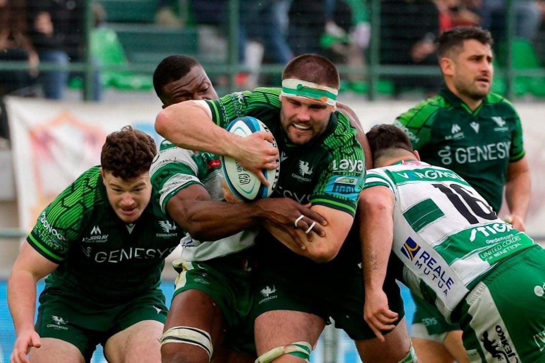 Connacht player being tackled by two players