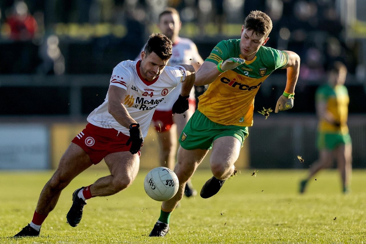 Tyrone footballer running with the ball