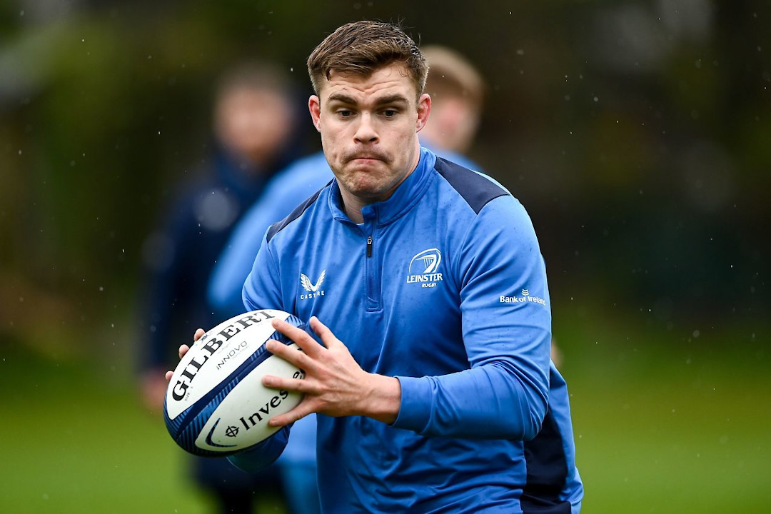 A Leinster Rugby player running with the ball during training