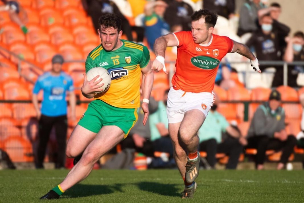 Armagh GAA player chases down a Donegal player with the ball