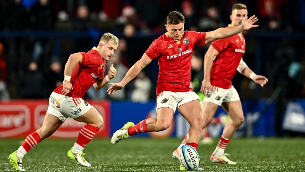 Munster player kicking the ball for a restart