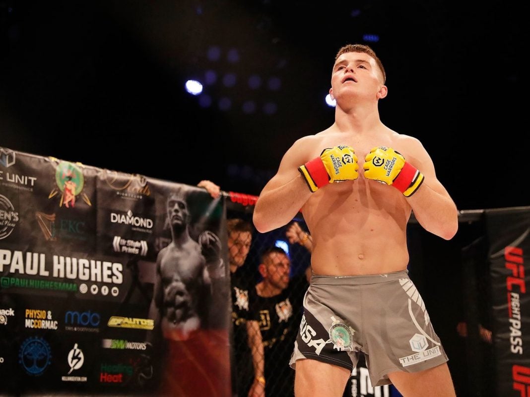 Paul Hughes flexing before a fight