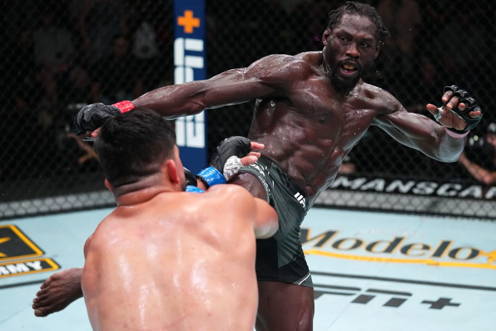 Jared Cannonier throws a body kick at Kelvin Gastelum