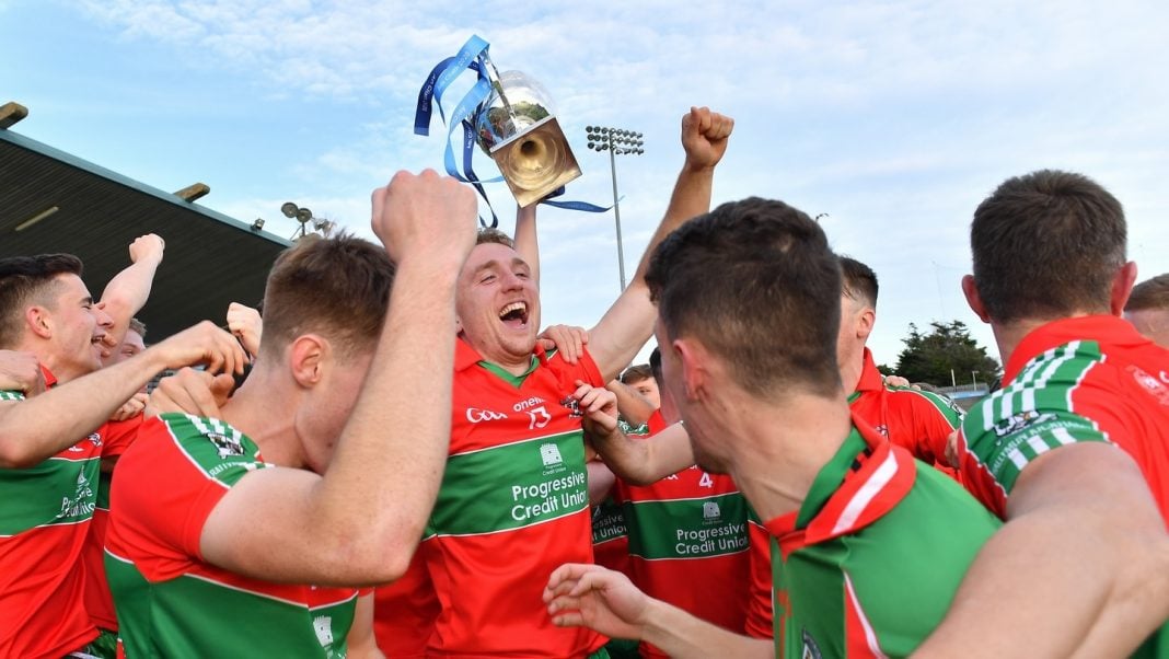 Ballymun Kickhams players celebrating with a trophy