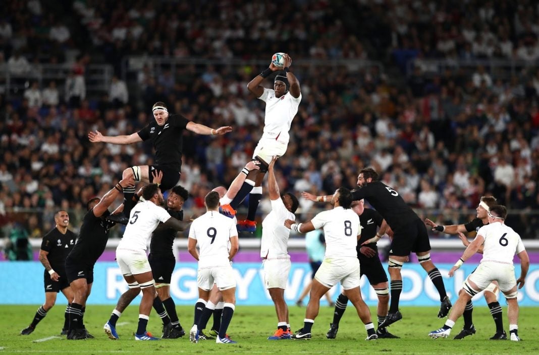 England rugby player jumps for the ball against New Zealand