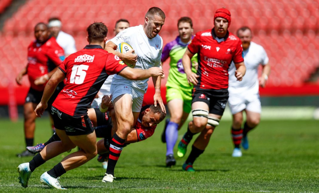 A photo of an Ulster Rugby player running with the ball