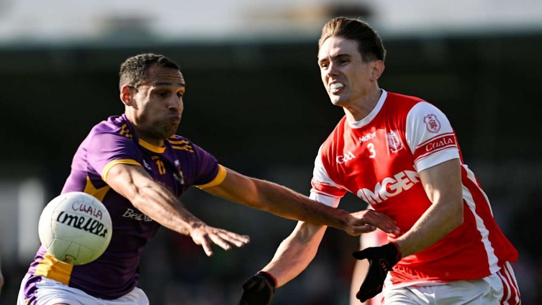 Cuala making a pass while a rival player tries to tackle