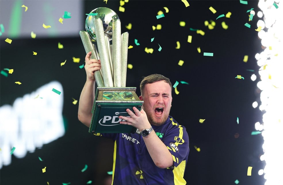Luke Littler lifting the PDC World Championship trophy