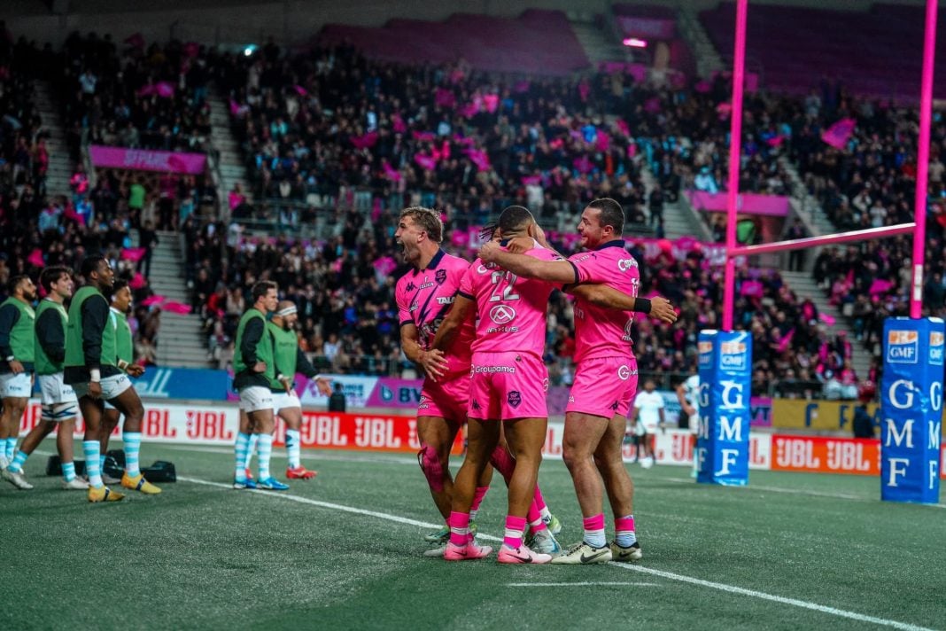 A photo of Stade Français Paris players celebrating a try under the posts