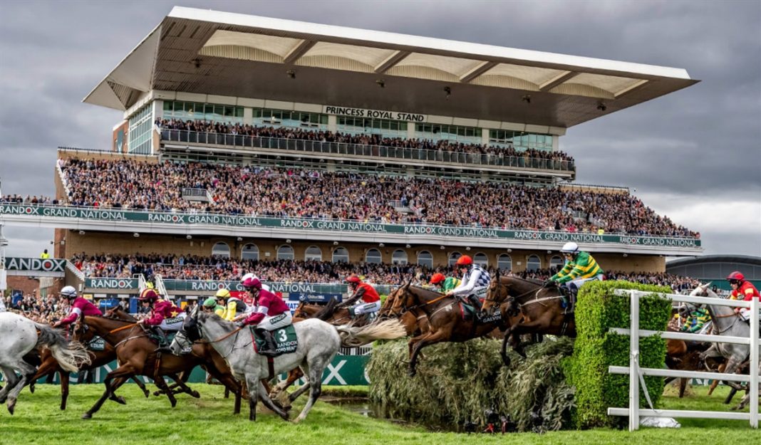 Horses jumping a fence at the Aintree Grand National