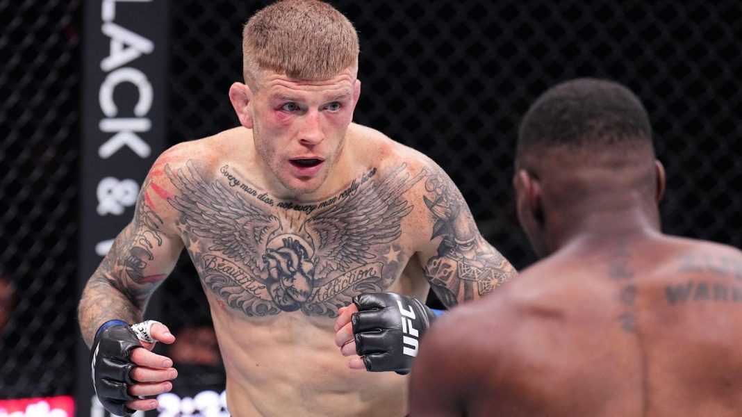 Chris Duncan squares up to another fighter in the octagon