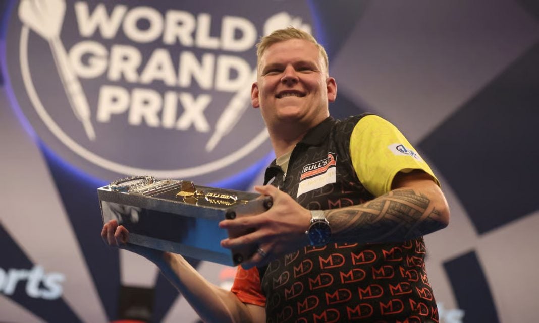 Mike de Decker lifting the World Grand Prix trophy after winning the tournament in 2024.