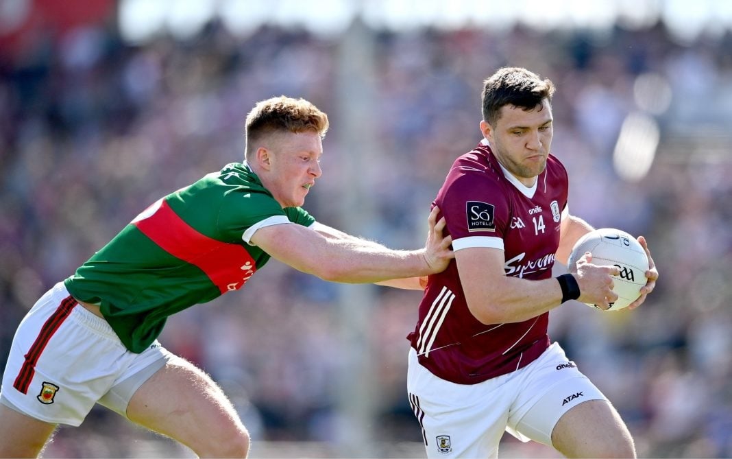 A Galway player avoids a Mayo tackle