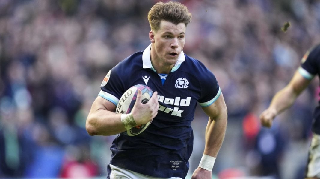 Scotland player Huw Jones running with the ball