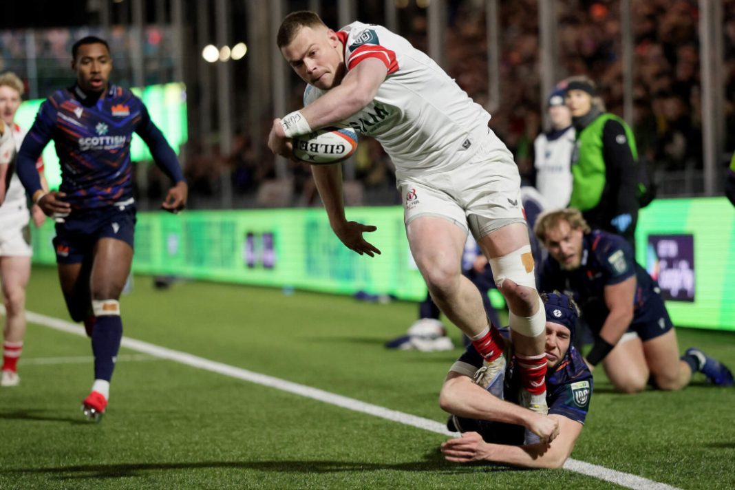 Ulster rugby player runs with the ball avoiding a tackle