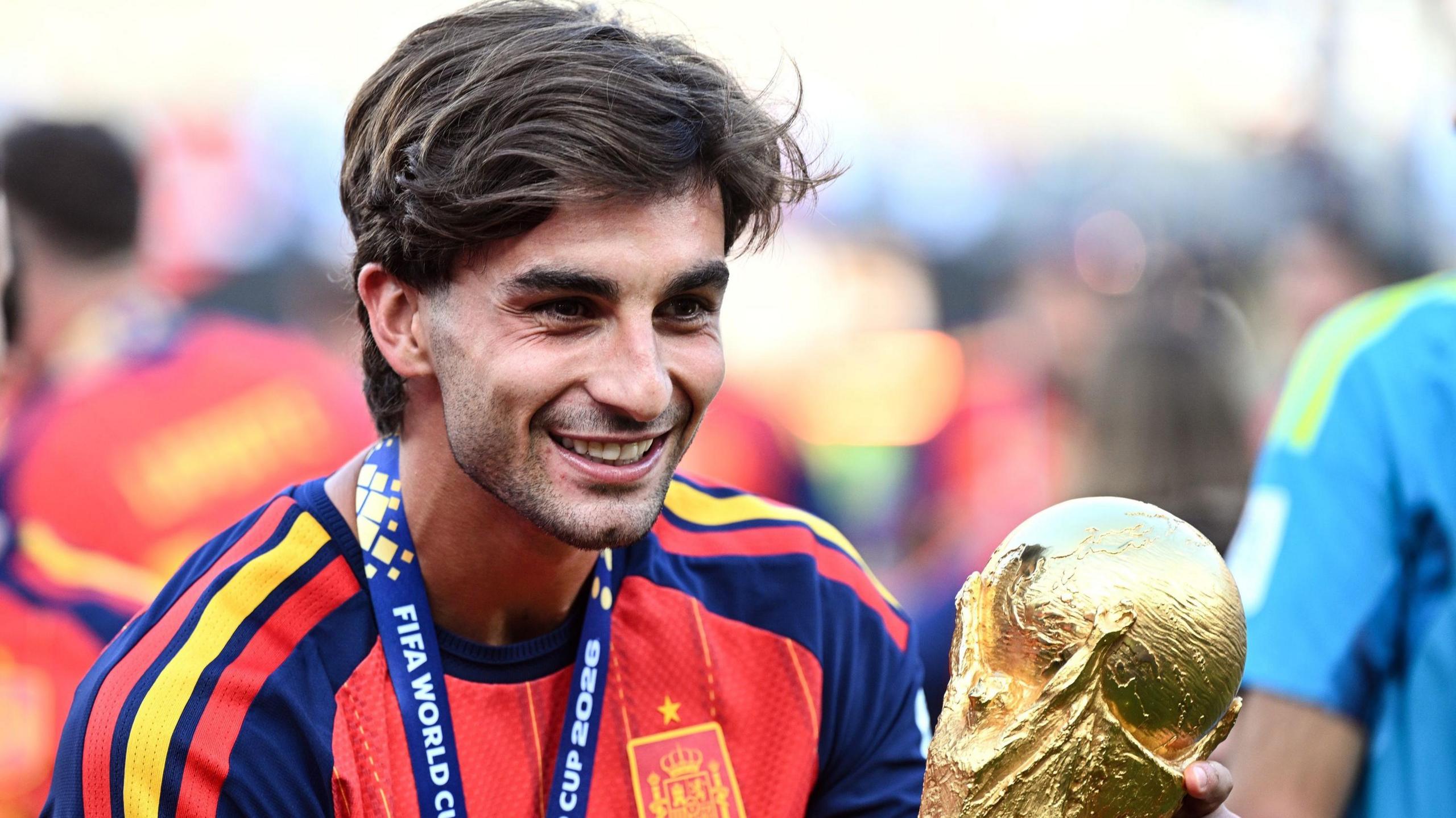 Ferran Torres holding a trophy for Spain