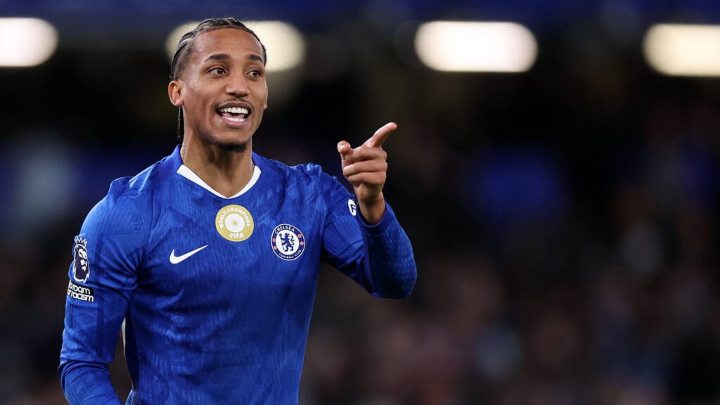 João Pedro pointing in a Chelsea shirt